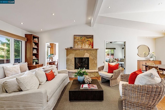 living room featuring lofted ceiling with beams, dark hardwood / wood-style flooring, and a fireplace