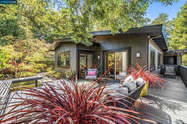 rear view of property featuring a deck