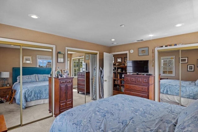 carpeted bedroom featuring two closets