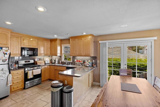 kitchen with light tile patterned flooring, stainless steel appliances, backsplash, and a healthy amount of sunlight