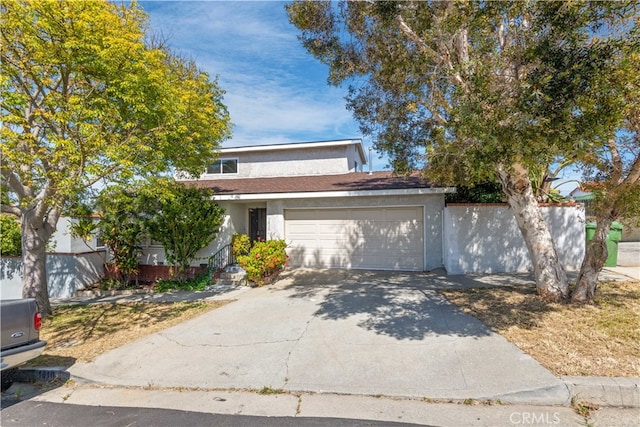 view of front of property with a garage, driveway, and stucco siding