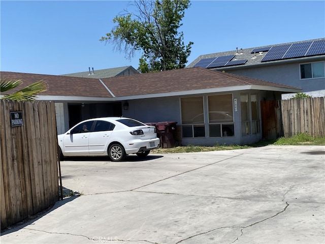 view of property exterior with solar panels