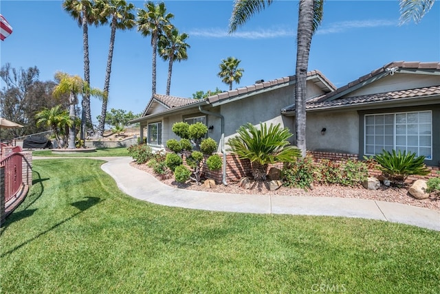 view of side of property with a yard