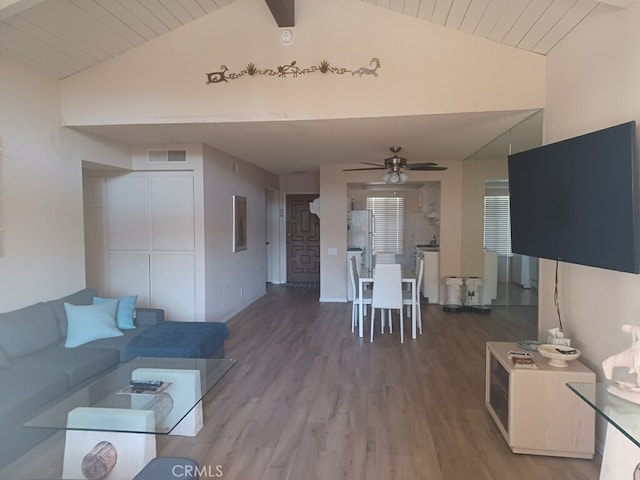 living room featuring hardwood / wood-style flooring, ceiling fan, wooden ceiling, and vaulted ceiling with beams