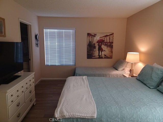 bedroom featuring dark hardwood / wood-style flooring