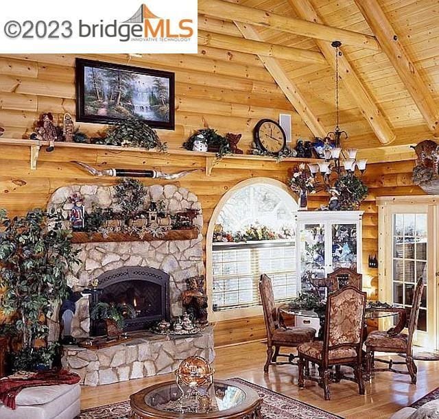 dining area with wood-type flooring, beam ceiling, a wealth of natural light, and wood ceiling