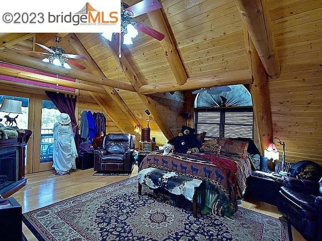 bedroom with ceiling fan, wooden walls, lofted ceiling with beams, wooden ceiling, and hardwood / wood-style floors