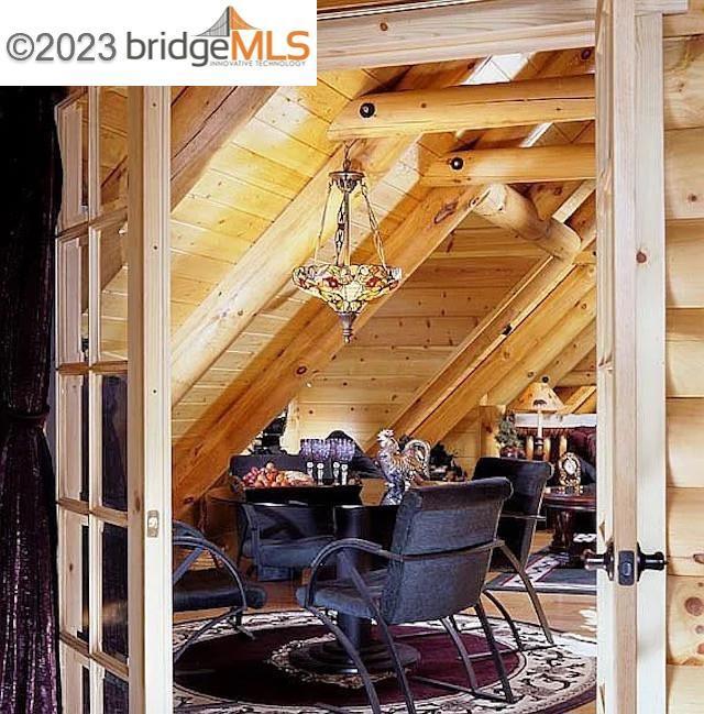 interior space featuring wood ceiling and lofted ceiling with beams