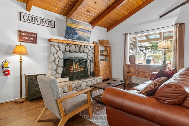 living room featuring wood ceiling, beam ceiling, hardwood / wood-style flooring, high vaulted ceiling, and a stone fireplace