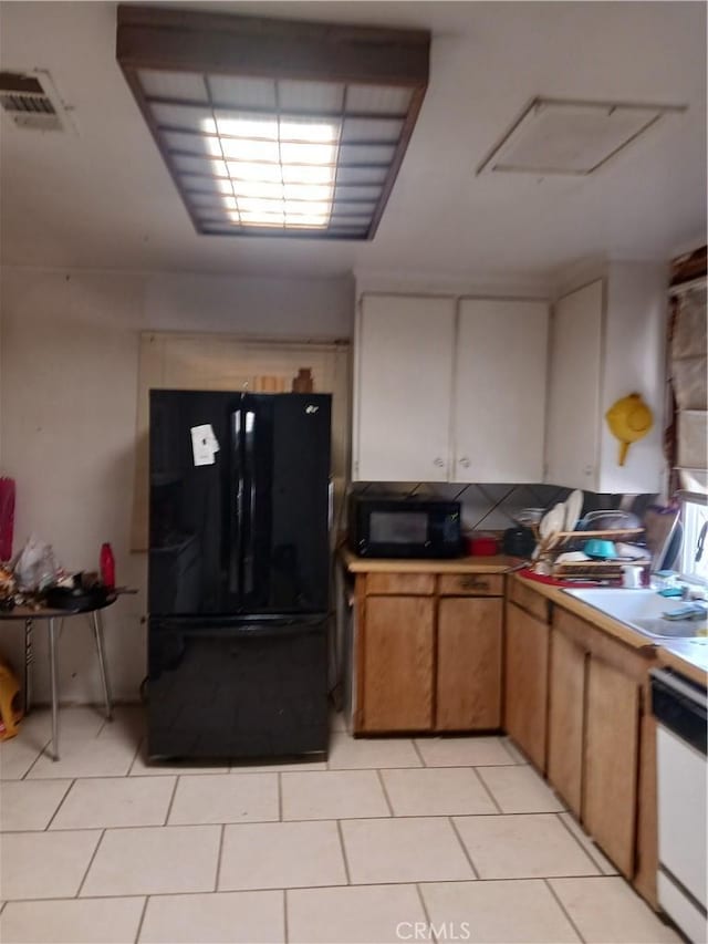 477 County Line Rd, Calimesa, CA 92320 - kitchen with black appliances, light tile patterned flooring, and light countertops
