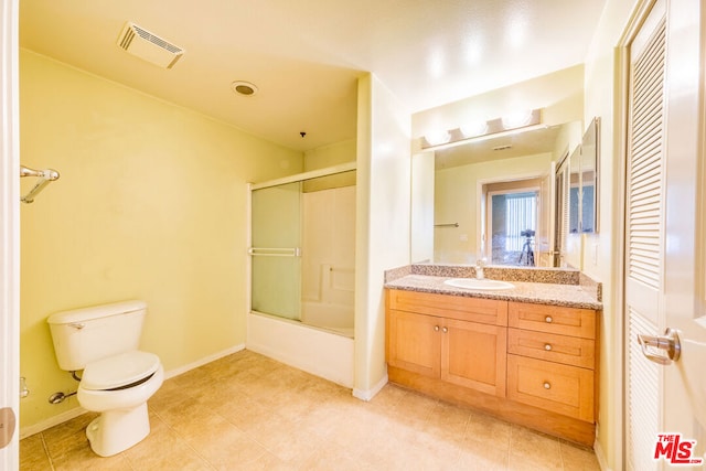 full bathroom featuring vanity, combined bath / shower with glass door, and toilet