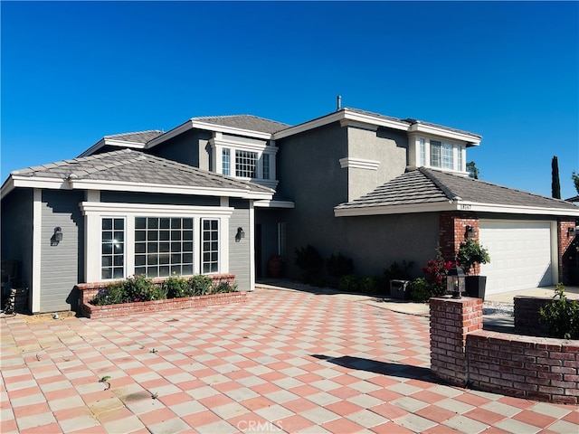 back of property with a garage