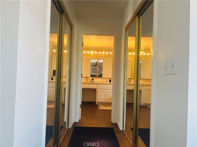 hallway with dark hardwood / wood-style flooring