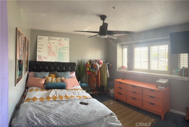 bedroom with a textured ceiling and ceiling fan