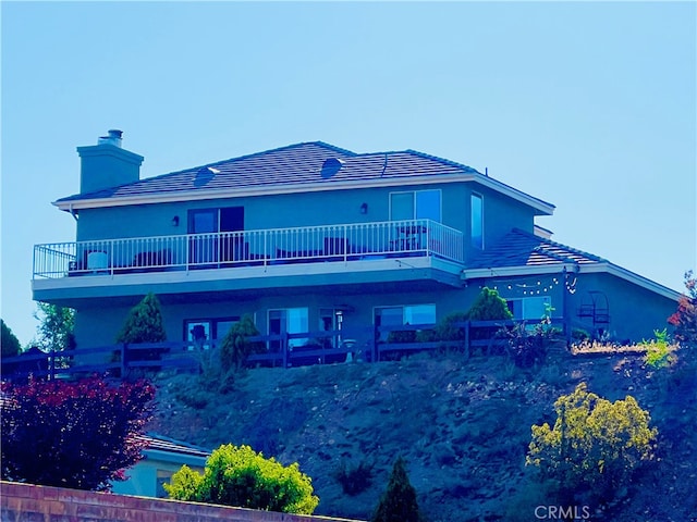 rear view of house featuring a balcony