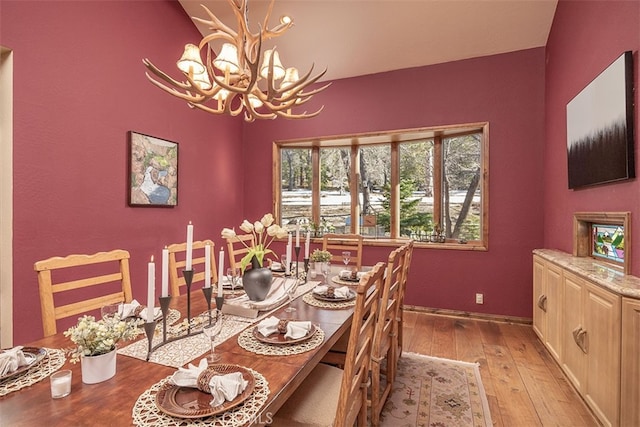 42143 Switzerland Dr, Big Bear, CA 92315 - dining area featuring a chandelier, light wood-type flooring, and baseboards