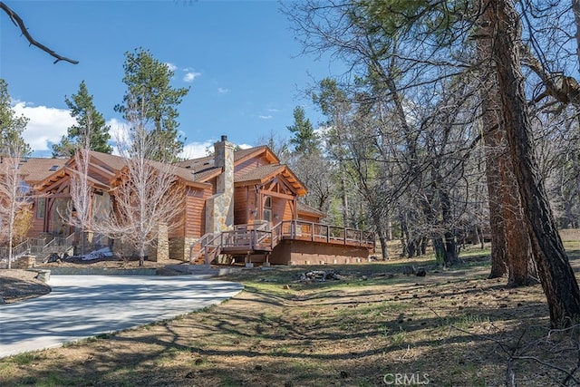 42143 Switzerland Dr, Big Bear, CA 92315 - back of property with a chimney, a deck, and stone siding