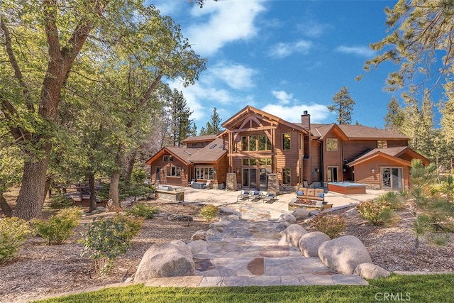 42143 Switzerland Dr, Big Bear, CA 92315 - rear view of property featuring a jacuzzi, a patio, and a chimney