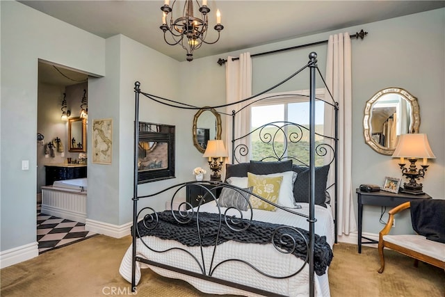 carpeted bedroom featuring an inviting chandelier