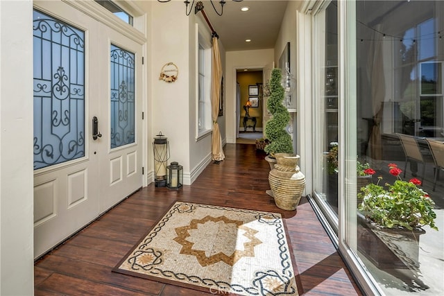 entryway featuring dark hardwood / wood-style floors and a notable chandelier