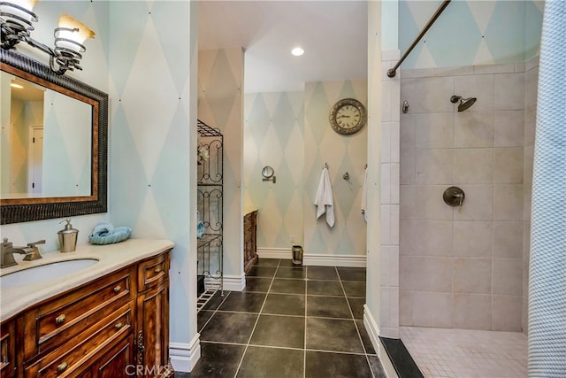 bathroom with vanity, a tile shower, and tile patterned floors