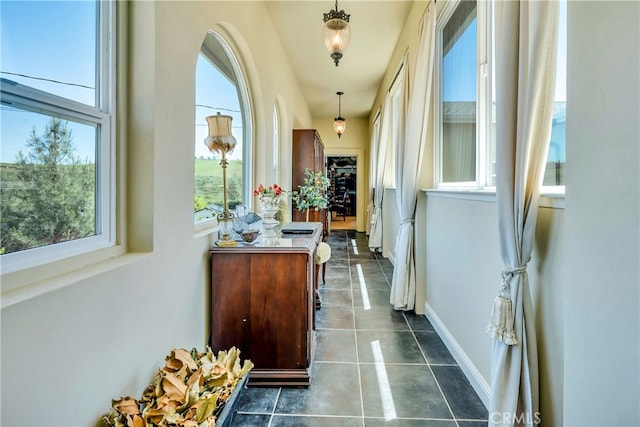 corridor featuring dark tile patterned floors