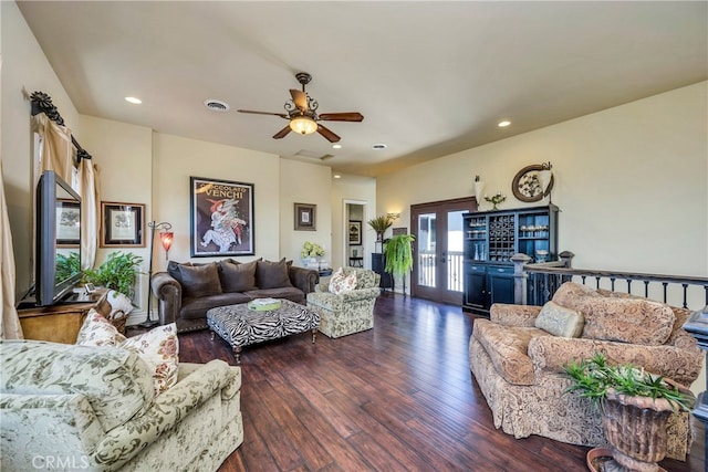 living room with ceiling fan and dark hardwood / wood-style floors