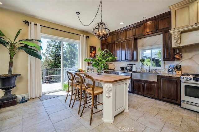 kitchen featuring butcher block counters, a healthy amount of sunlight, gas stove, and decorative backsplash