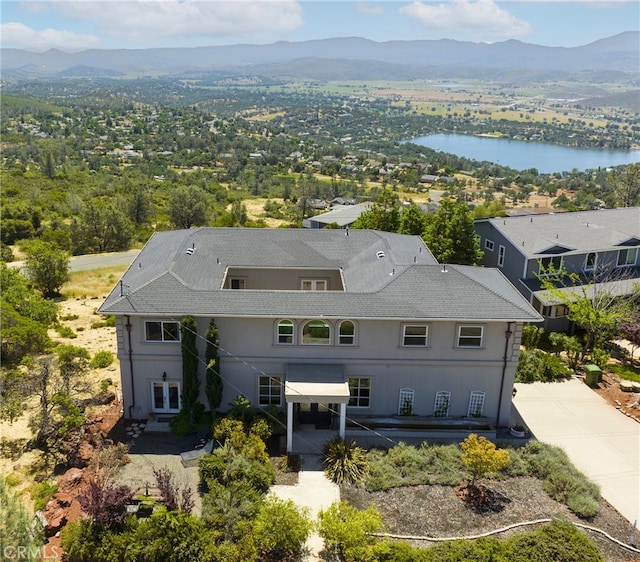 drone / aerial view featuring a water and mountain view