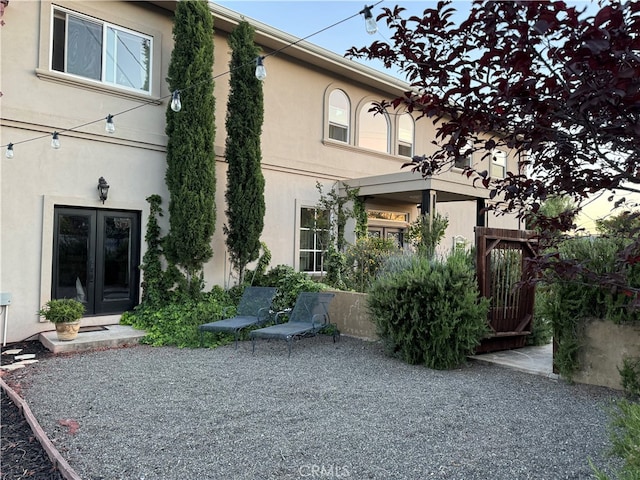 back of property with french doors and a patio