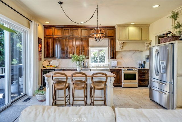 kitchen featuring stainless steel appliances, hanging light fixtures, decorative backsplash, and a healthy amount of sunlight