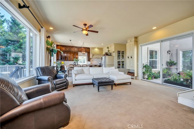 carpeted living room featuring ceiling fan