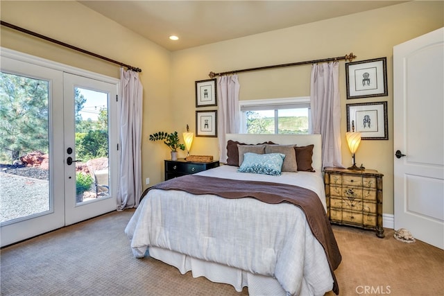 carpeted bedroom featuring access to exterior, multiple windows, and french doors