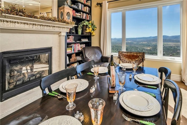 15893 Little Peak Rd, Hidden Valley Lake, CA 95467 - dining room with a tiled fireplace, a mountain view, and wood finished floors