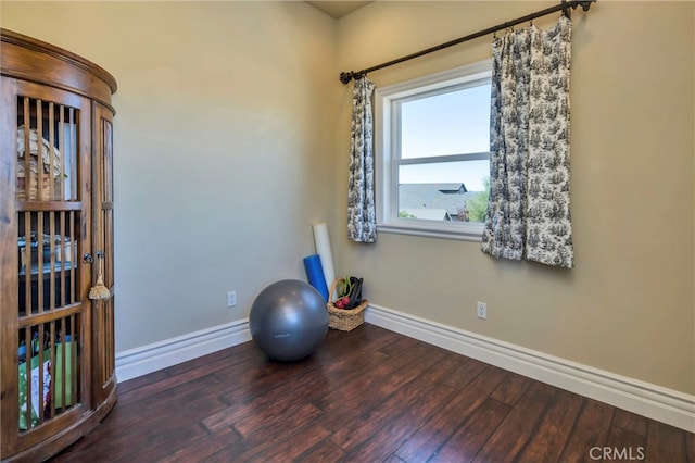 workout area with dark wood-type flooring