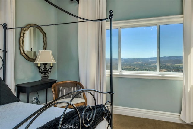 bedroom with a mountain view and carpet