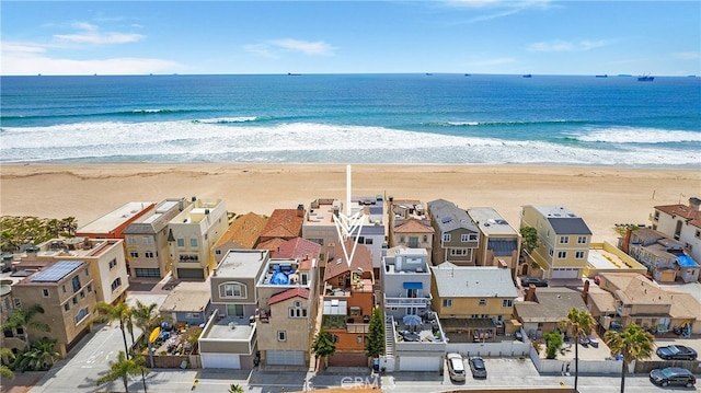 birds eye view of property with a beach view and a water view