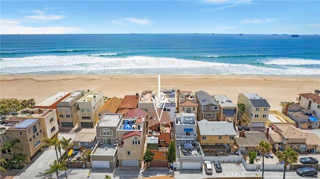 drone / aerial view with a water view and a beach view