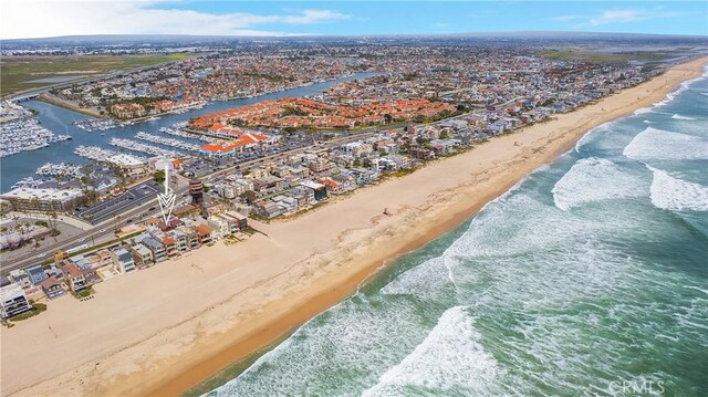 drone / aerial view featuring a beach view and a water view