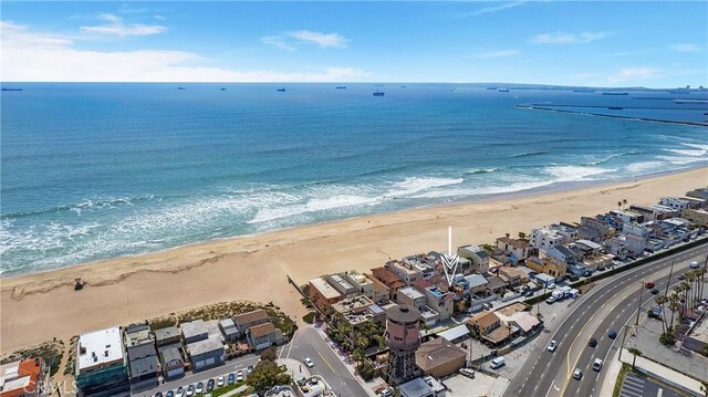 bird's eye view with a water view and a beach view