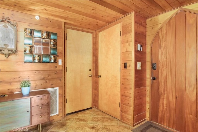 hallway with wood ceiling and wooden walls