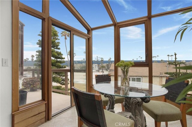 sunroom / solarium featuring lofted ceiling and plenty of natural light