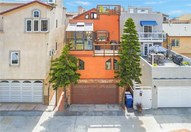 view of front of home featuring a balcony and a garage