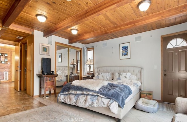 bedroom featuring light tile patterned flooring, wooden ceiling, beam ceiling, and a closet