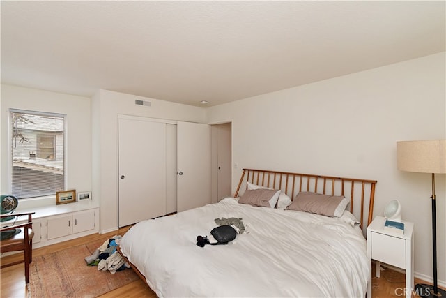 bedroom featuring light hardwood / wood-style flooring and a closet