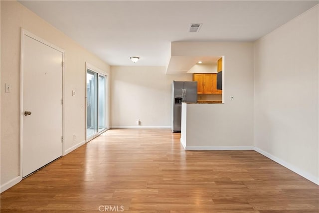 unfurnished room with light wood-type flooring