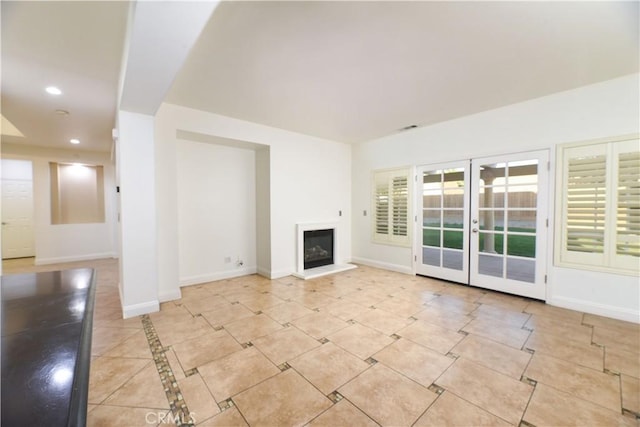 unfurnished living room featuring french doors