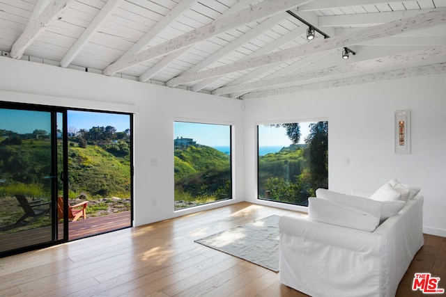 sitting room featuring wood-type flooring, lofted ceiling with beams, and wood ceiling