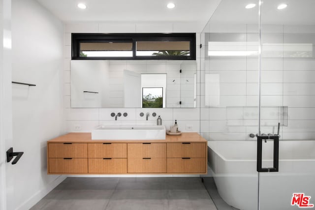 bathroom with vanity, a tub, and tasteful backsplash