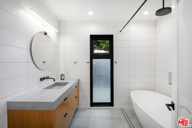 bathroom featuring vanity, tile walls, and plus walk in shower